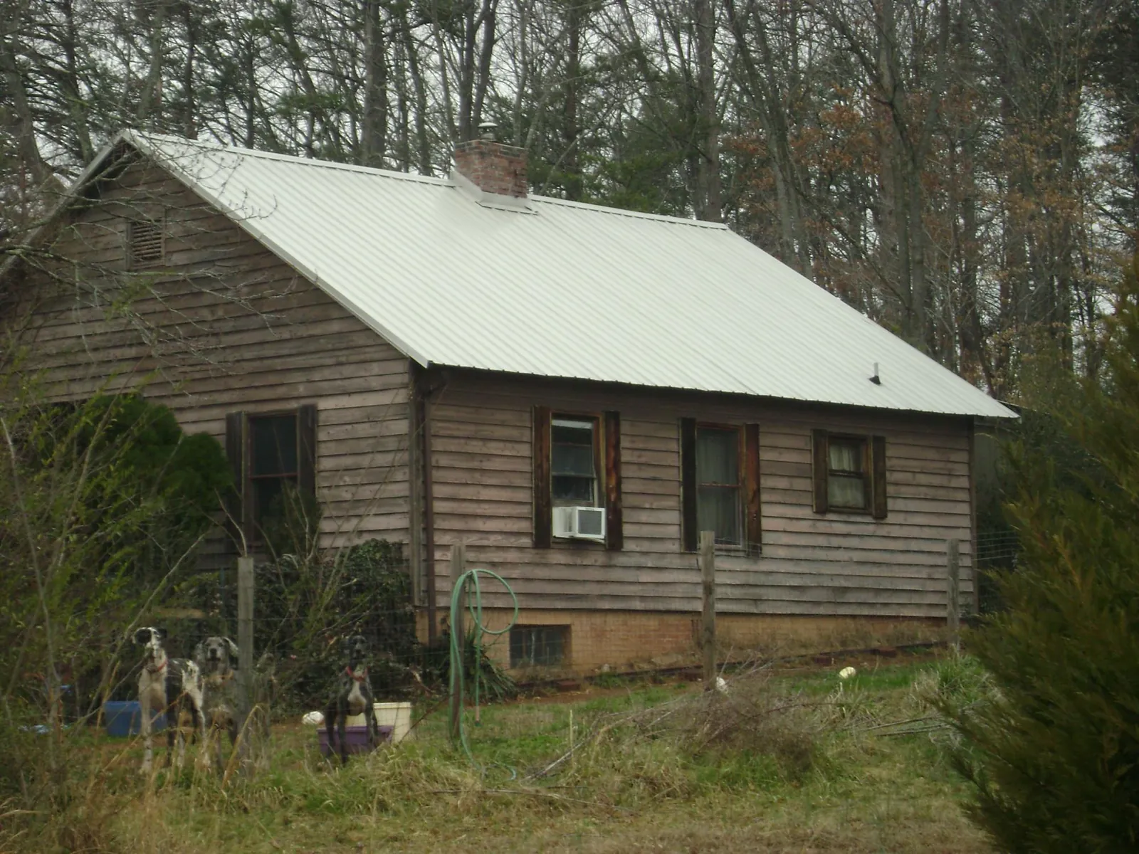 White metal roof on an old wood sided farmhouse, from a Metal Roof Installation job in Westwego